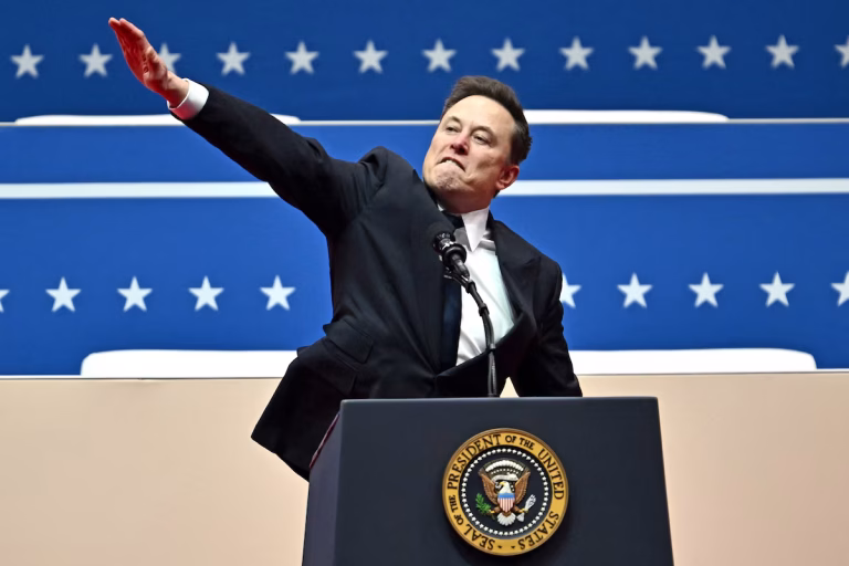 Elon Musk gestures as he speaks during the inaugural parade Jan. 20 in Washington, D.C. (Angela Weiss/AFP/Getty Images)