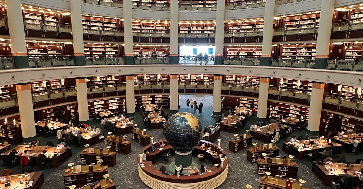 A large modern library interior with a central globe and multiple reading desks. Aerial view.