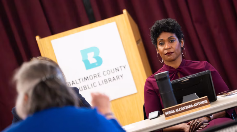 Baltimore County Public Library CEO Sonia Alcántara-Antoine listens to grievances from concerned librarians and community members during an emergency meeting in Towson on Tuesday. (Kaitlin Newman/The Banner)
