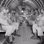 American paratroopers, heavily armed, sit inside a military plane as they soar over the English Channel en route to the Normandy French coast for the Allied D-Day invasion of the German stronghold during World War II, June 6, 1944. Nearly 160,000 Allied troops landed in Normandy on June 6, 1944. AP File Photo